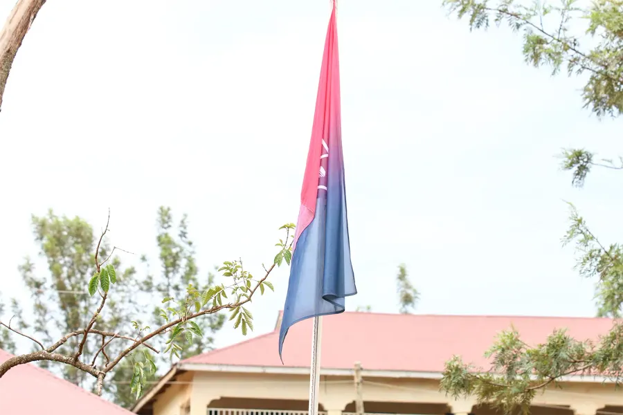 The Sikri Academy flag flying over the campus